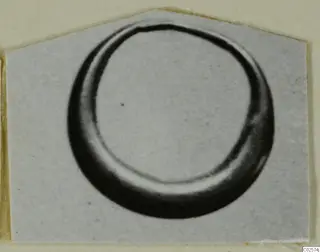 Ring from Enkomi shown in a close view, a thick curved band with an open centre