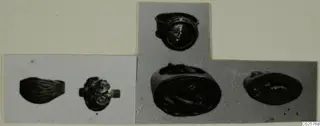 Photographs of five rings from Enkomi, cut out and mounted together on a card