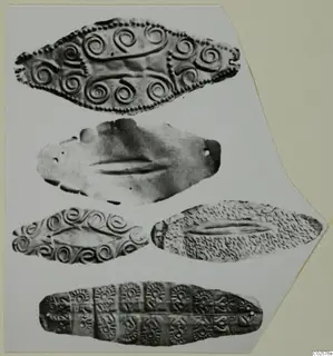 Five flat, leaf-shaped objects with spiral, dotted and stamped decoration, mounted on a pale card.