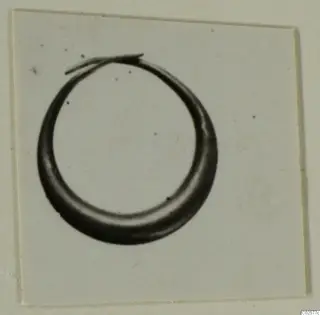 Metal hoop earring from Enkomi with overlapping ends, shown as a single object.