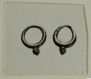 Two loop earrings with cluster-knobbed ends, shown side by side on a plain pale card