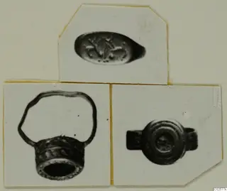 Three photographs on a card mount of finger rings and an oval engraved stone