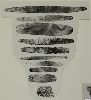Photo mounted on card of nine narrow metal strips and one embossed fragment, Enkomi finds
