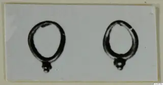 Two ring-shaped jewellery items, each with a small knobbed cluster at the base, shown on a card mount.
