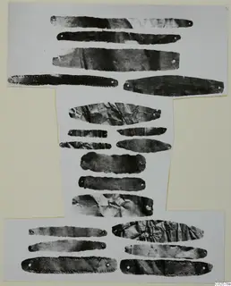 Thin metal strips with punched holes, arranged in rows on a white card mount, Enkomi Bronze Age gold and silver