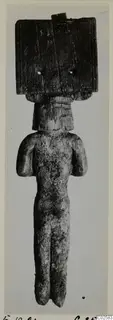 Small carved standing figure with a broad rectangular head block and arms held at its sides, from Enkomi.