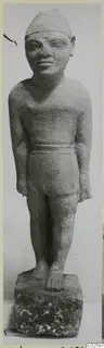 Limestone statue of a standing male figure with arms at its sides and a cap-like headdress, from Ayia Irini