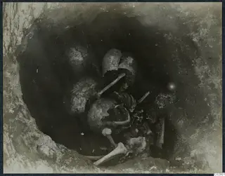 Tomb 6 at Enkomi: skeleton and broken vessels in the tomb chamber during excavation