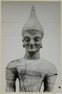 Terracotta Proto-Cypriote II figure: head and upper body with a tall conical headdress and large eyes