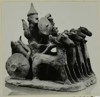 Terracotta group of a horse-drawn vehicle with two standing figures, one holding a round shield