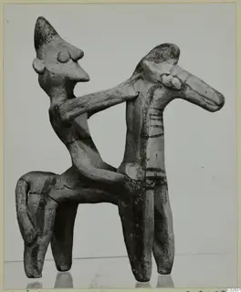 Terracotta figurine of a figure riding a four-legged animal, one arm around its neck, with dark painted stripes.