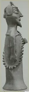 Terracotta figurine in profile from Ayia Irini, with a long neck, bent arms and notched decoration around the body.