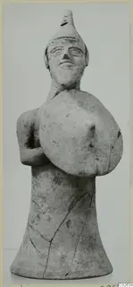 Terracotta figurine of a standing figure holding a round shield, from Ayia Irini