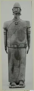 Terracotta figure of a standing human figure in a cap and necklace, from Ayia Irini