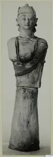 Terracotta statue of a standing figure with a tall headdress, photographed full length against a plain background