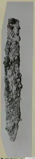 Pointed iron tool, heavily corroded, shown upright.