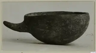 Black-slipped pottery bowl with a long handle, from Ayios Iakovos