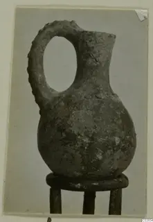 Pottery jug with a loop handle and narrow neck, from Ayios Iakovos, shown on a wooden stand
