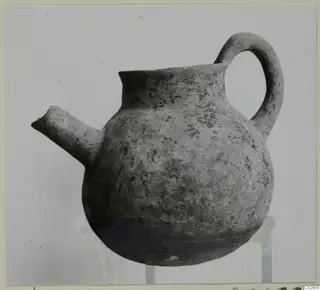 Pottery Black Slip Ware jug with a side spout and loop handle