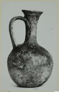 Black Lustrous Ware jug from Ayios Iakovos with a single loop handle and flaring mouth