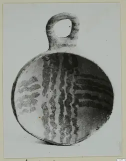 Pottery White Painted IV-V: a round vessel with a loop handle and dark wavy painted bands, from Ayios Iakovos