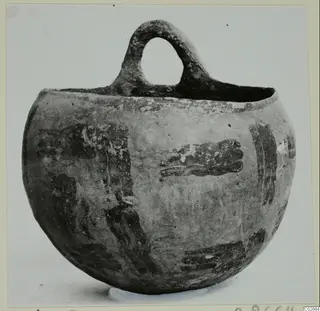 Globular vessel with a single loop handle and dark painted bands and blotches on a pale surface