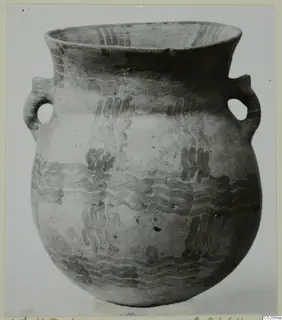 Two-handled White Painted pottery vessel from Ayios Iakovos, with dark wavy painted bands on a pale surface