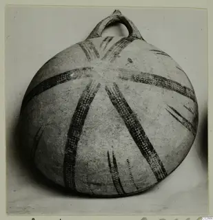 Round vessel with a loop handle and dark radiating painted bands, from Ayios Iakovos