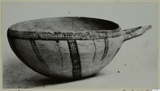 Pottery White Slip Ware bowl with a tubular handle and dark painted bands