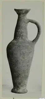Base-Ring Ware bottle with a flared rim, tall neck and single loop handle, seen from the front