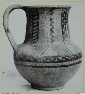 Wheel-made jug with a single loop handle and dark painted chevron, lattice and band decoration, from Ayios Iakovos