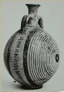 Pottery bottle with a flaring neck, two loop handles and dark painted bands and concentric circles, from Ayios Iakovos