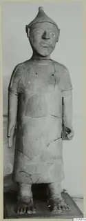 Standing terracotta figure with a conical cap and long tunic, from Ayia Irini