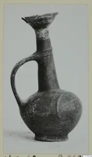 Pottery Base-Ring Ware jug with a flared mouth, tall neck and single handle, photographed against a plain background
