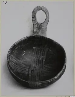 Shallow bowl with a vertical loop handle, its interior decorated with criss-cross bands of dark lines
