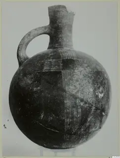 Globular amphora with a single loop handle, tall neck and incised line pattern on the body, from the Karpas sites
