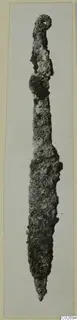 Corroded iron knife-like tool from Marion, photographed on a card mount.
