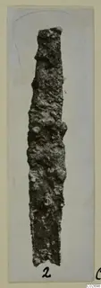 Corroded iron knife blade from Marion Tombs 6 A and 6 B, shown on a mounted card.