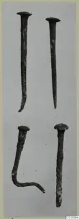 Four corroded nails with domed heads, one bent into a hook, from Tomb 16 at Marion.