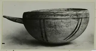 Pottery White Slip Ware bowl with a side handle and black painted bands, from Ayios Iakovos