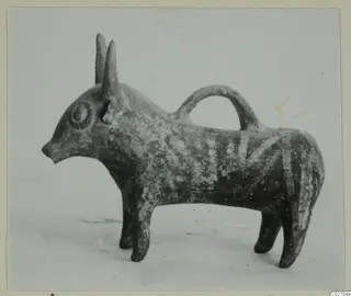 Pottery Base-Ring Ware vessel shaped as a horned animal, with a loop handle arching over its back
