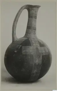 Jug with a rounded body, tall neck and strap handle, decorated with light parallel-line bands on a dark surface