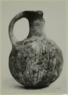 White Painted juglet with a single loop handle and vertical painted lines on its rounded body