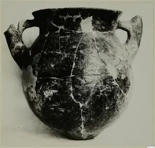 Two-handled pottery vessel with a dark polished surface and cracks, from Lapithos, Vrysi tou Barba tombs