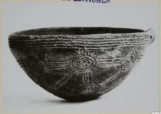 Pottery Red Polished III Bowl from Lapithos, shown in profile with incised concentric circles and lines