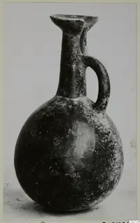Pottery Red Polished III jug from Lapithos, with a single loop handle and a rounded body