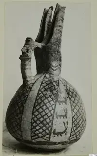 Pottery vessel from Ayios Iakovos with two tall spouts, a tubular handle and painted lattice and band decoration