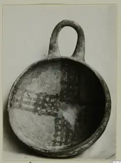 White Painted IV-V bowl from Ayios Iakovos with a loop handle and dark painted checkered and banded decoration