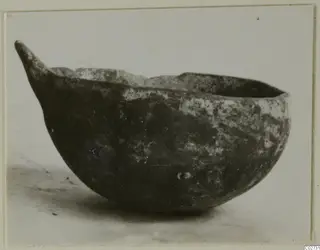 Black Slip Ware bowl with a pointed handle, seen from the side