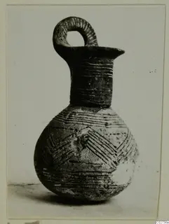 Red Polished III jug from Amathus, with a looped handle and incised bands and chevron decoration
